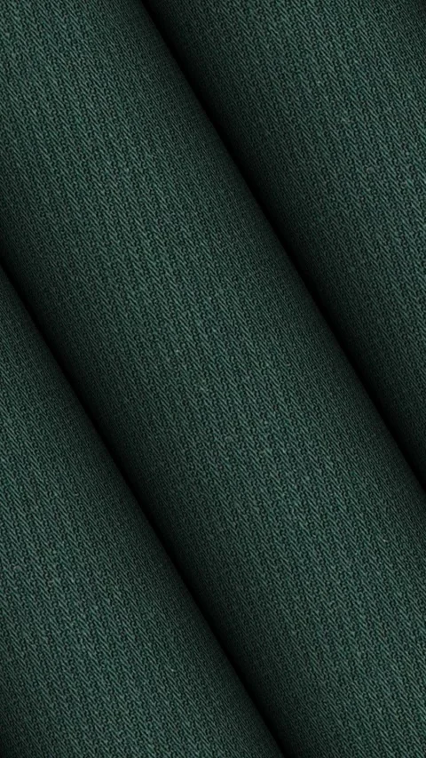 Dynamic rotating rolls of Italian dark pine green wool twill fabric tone 스톡 동영상 343211893