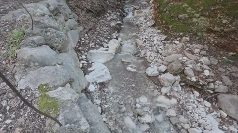 Dynamic Rotating Shot of River Flow with Foam in Mountain Forest Gorge Stock Footage 338109781