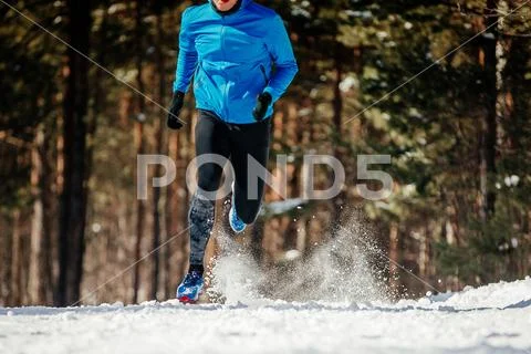 Dynamic running on winter trail Stock Photos