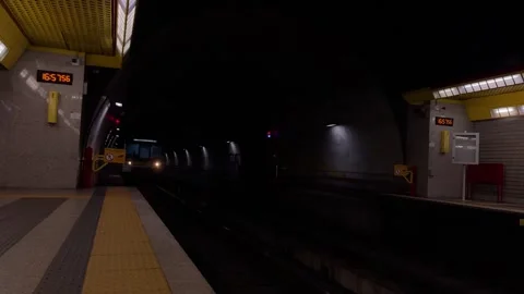 A dynamic scene inside a metro station, capturing the rush of an approaching tra 動画素材 322150717