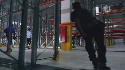 Dynamic scene with lots of people on the rollers in the logistics center Video stock 104307164