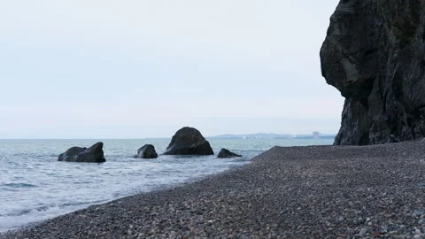 Dynamic Sea Waves Crashing on a Pebble Shore Stock Footage 330302264