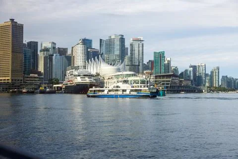 Dynamic SeaBus ferry navigating Burrard Inlet towards Vancouver's iconic sk.. Stock Photos