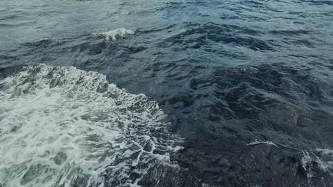 A dynamic sequence showcasing powerful ocean waves crashing against a rocky Video stock 338266534