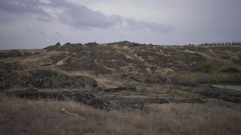 Dynamic shooting of rocky slopes surrounding a lake Stock Footage 125612834