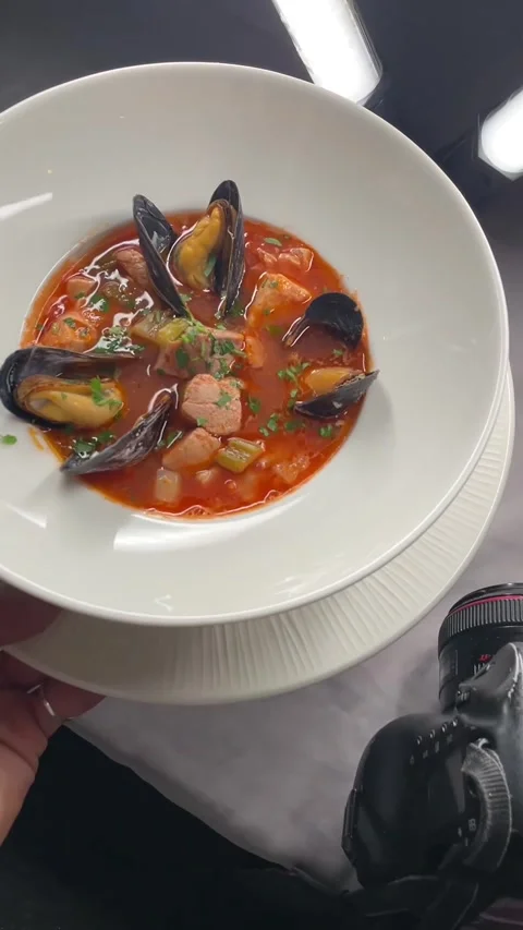 Dynamic shot of chef serving hot mussel stew amid bustling culinary activity Stock Footage 335671418