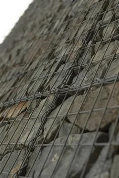 Dynamic shot emphasizing pattern of interconnected stones and metal ties Stock Photos
