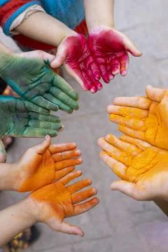 Dynamic Shot of Hands Smeared with Bright Holi Powders, Capturing Festive E.. Stock-Fotos
