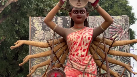 A dynamic shot of Maa Durga Idol in saree with orange and white pattern on it Stock Footage 295601453