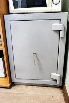 Dynamic shot of an old dilapidated closed safe in the office. It is painted.. Stock Photos