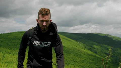 Dynamic shot of young man hiking in the mountains, walking in nature 4K. Stock Footage 234569848