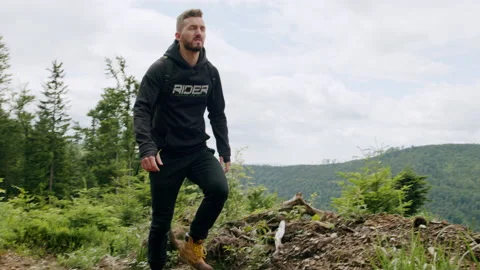 Dynamic shot of young man hiking in the mountains, walking in nature 4K. Stock Footage 234616172