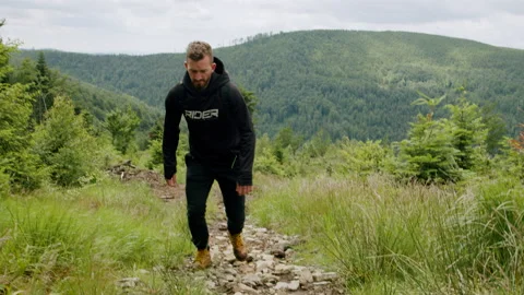 Dynamic shot of young man hiking in the mountains, walking in nature 4K. Stock Footage 234617837
