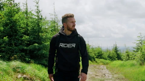 Dynamic shot of young man hiking in the mountains, walking in nature 4K. Stock Footage 234620002