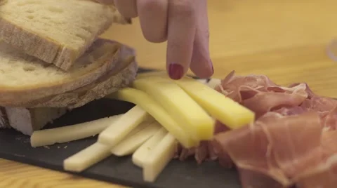 Dynamic shots of cheese, bread, ham, olives and some red wine, on a stone board. Stock Footage 67274796