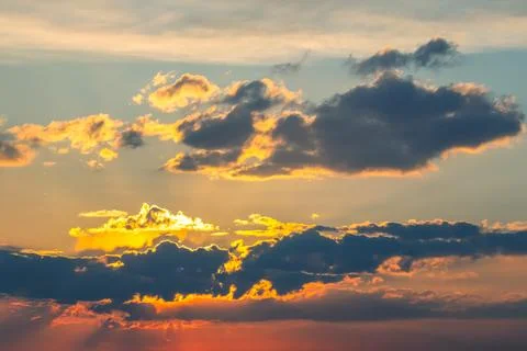 Dynamic sky with towering dark clouds and brilliant sunlight rays cutting t.. Stock Photos