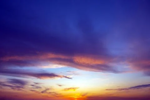 Dynamic sky with towering dark clouds and brilliant sunlight rays cutting t.. Stock Photos