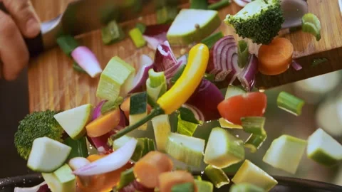 Dynamic slow motion footage of colorful chopped fresh vegetables falling fr.. Stock Footage 337411226