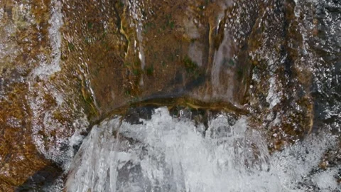 Dynamic slow motion shot of natural river current flowing through concrete water Stock Footage 346773959