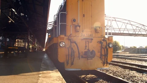 Dynamic slow motion shot yellow train waiting at station Stock Footage 88380894