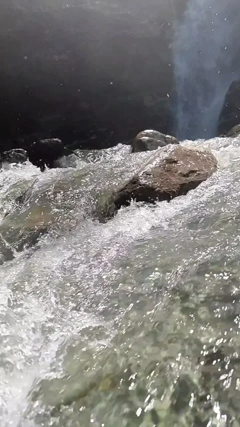 Dynamic Slow Motion Water Flow from a Small Waterfall Stock Footage 328297808