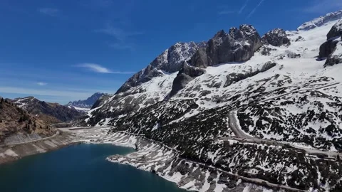 Dynamic Slow Pan Across Lago di Fedaia Shoreline and Dolomites Glaciers Stock Footage 339791254
