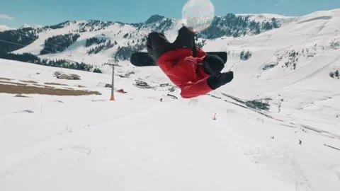Dynamic Snowboarder Performing Tricks in Scenic Mountain Landscape Stock Footage 323835999
