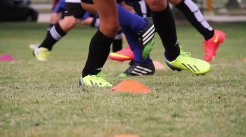 Dynamic Soccer Practice: Kids Training Footwork with Diverse Sports Gear on Turf Stock Footage 40521271