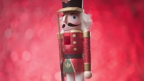 Dynamic spinning of a Toy Nutcracker in front of a bright bokeh studio, Stock Footage 321681063
