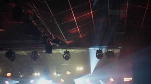 Dynamic Stage Lights Beaming Through Smoke in Dark Venue Stock Footage 335276256