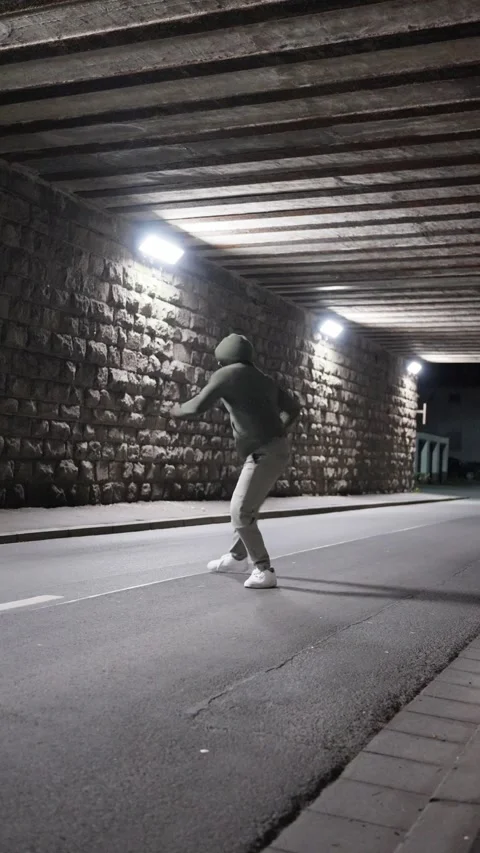 Dynamic Street Movement within an Underpass A Captivating Urban Dance Sequence Stock Footage 307221617