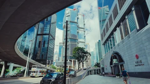 A dynamic street view of bustling Hong Kong with towering skyscrapers and Stock Footage 338311550