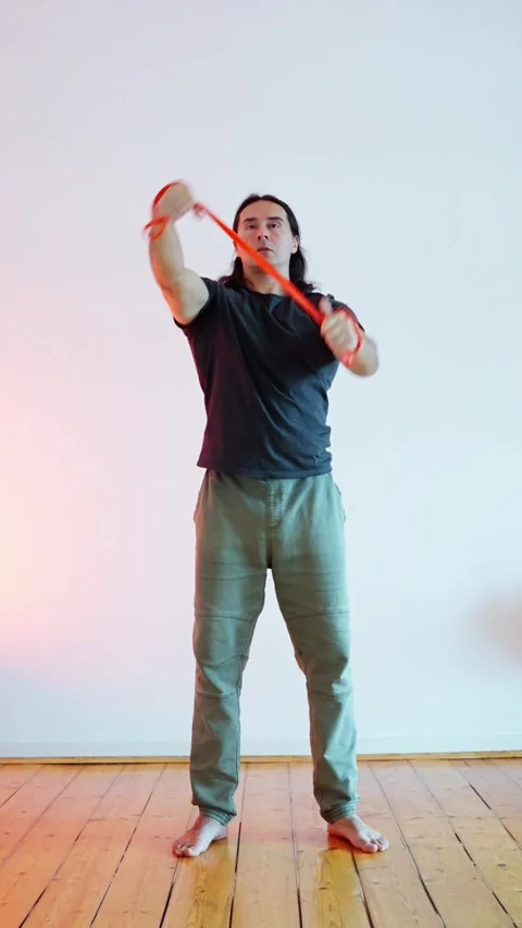 Dynamic Stretching Routine Incorporating a Resistance Tool for Overall Fitness Stock Footage 304801679