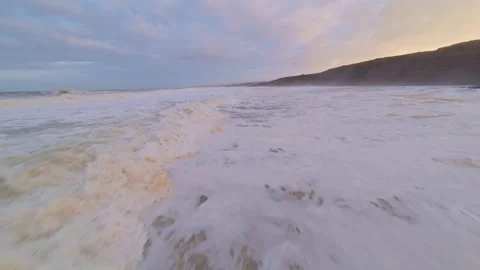 Dynamic surf scene with waves washing over sand Video stock 344672707