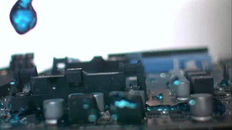 Dynamic sweep across circuit board as blue liquid floods through. Slow motion. Stock Footage 64884075
