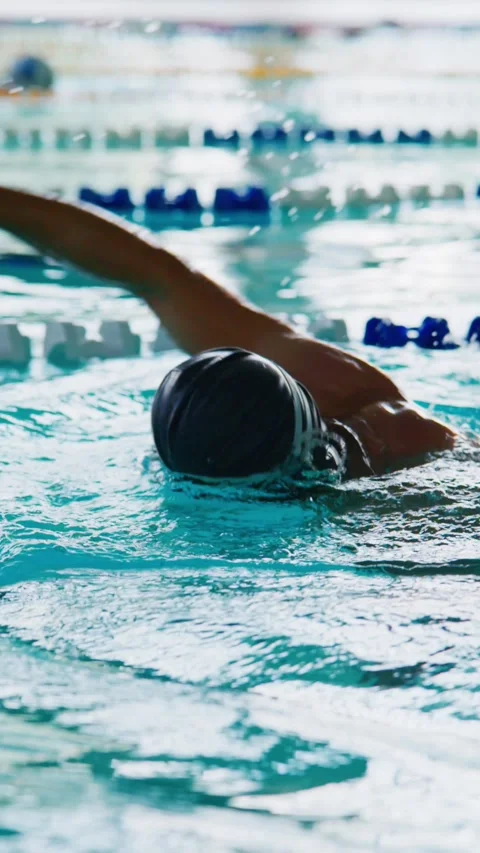 Dynamic swimmer glides through pool with rhythmic arm motion Stock Footage 346458120