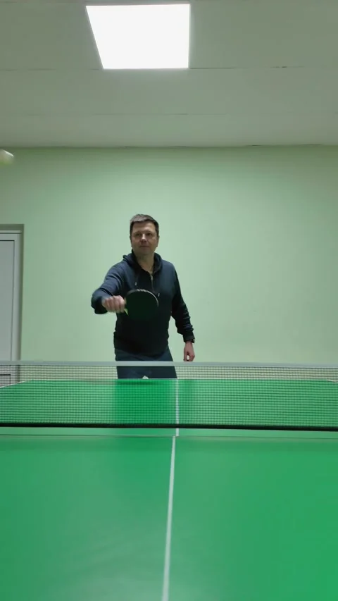 Dynamic Table Tennis Player Captured from Low Angle During Practice Shot. V.. Stock Footage 302456495