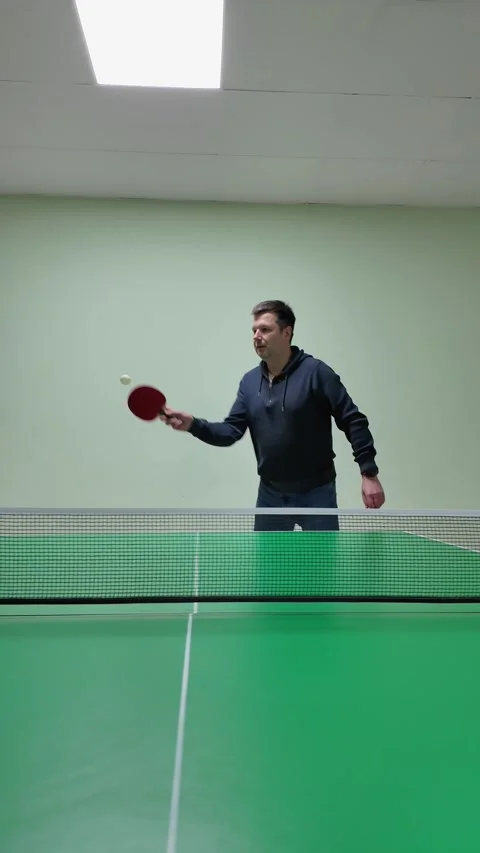 Dynamic Table Tennis Player Captured in Vertical Tracking Shot from Low Ang.. Stock Footage 305459196