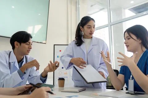 Dynamic team meeting. Doctors collaborating on healthcare solutions with 写真素材