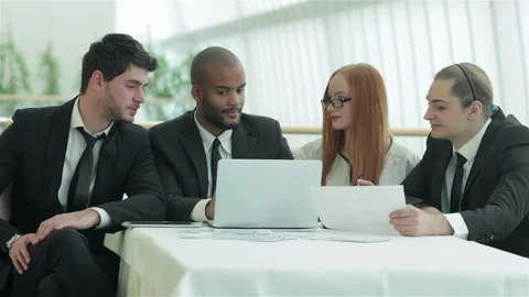 Dynamic team of young professionals engaged in a lively coffee meeting Vídeos de archivo 311814066