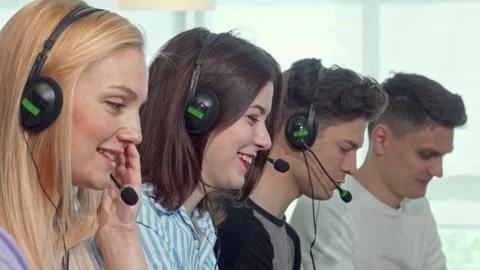 Dynamic team of young professionals in headsets collaborating at a call center Stock Footage 311201134