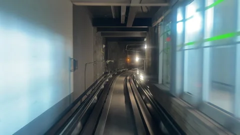 Dynamic timelapse curved train tracks rushing through modern illuminated Stock Footage 337948948