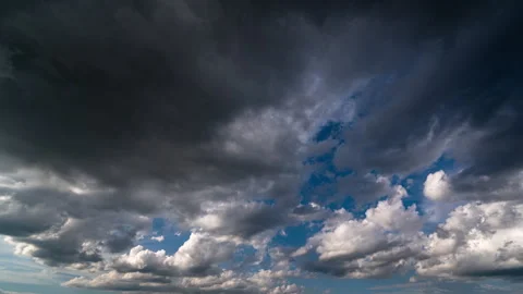 Dynamic timelapse of dark storm clouds gathering across a blue sky creating... Stock Footage 341774205