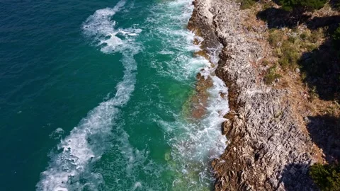 Dynamic Top-Down Aerial View of Turquoise Sea Waves Breaking Stock Footage 340829528