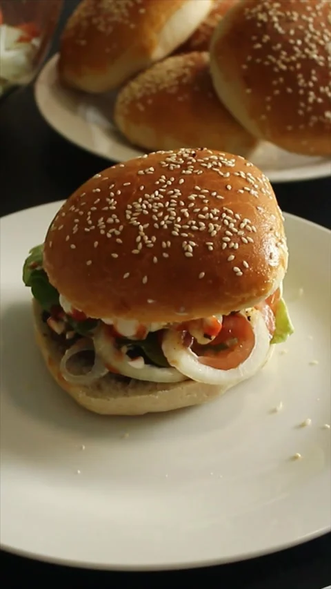 Dynamic top-down shot of a delicious homemade burger. Stock Footage 303934647