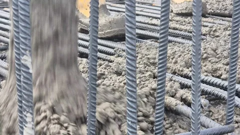Dynamic Tracking Shot of Concrete Pouring on Rebar Stock Footage 336430374