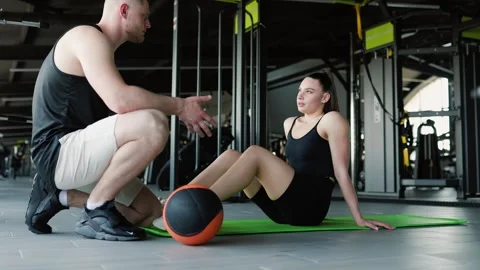 Dynamic Training Session with Ball Led by Hispanic Personal Trainer Stock Footage 245663559