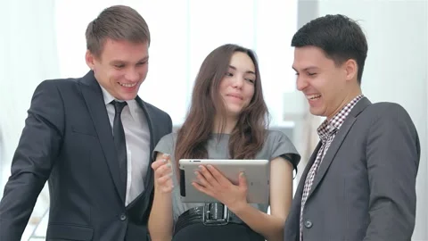 Dynamic trio of young professionals celebrating business success Stock Footage 311809726