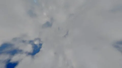 Dynamic Upward Flight Shot through Soft Fluffy White Clouds with the Bright.. Stock Footage 334244891