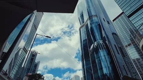 A dynamic upward journey through the dense urban skyline of Hong Kong, viewed Video stock 338311561